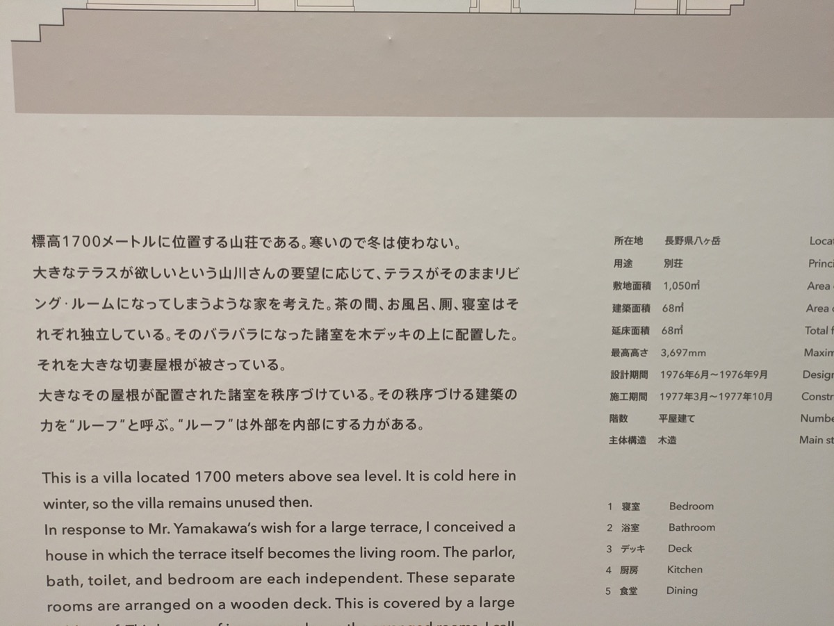 山本理顕展の解説パネル。日本語と英語で建築作品の説明が書かれている